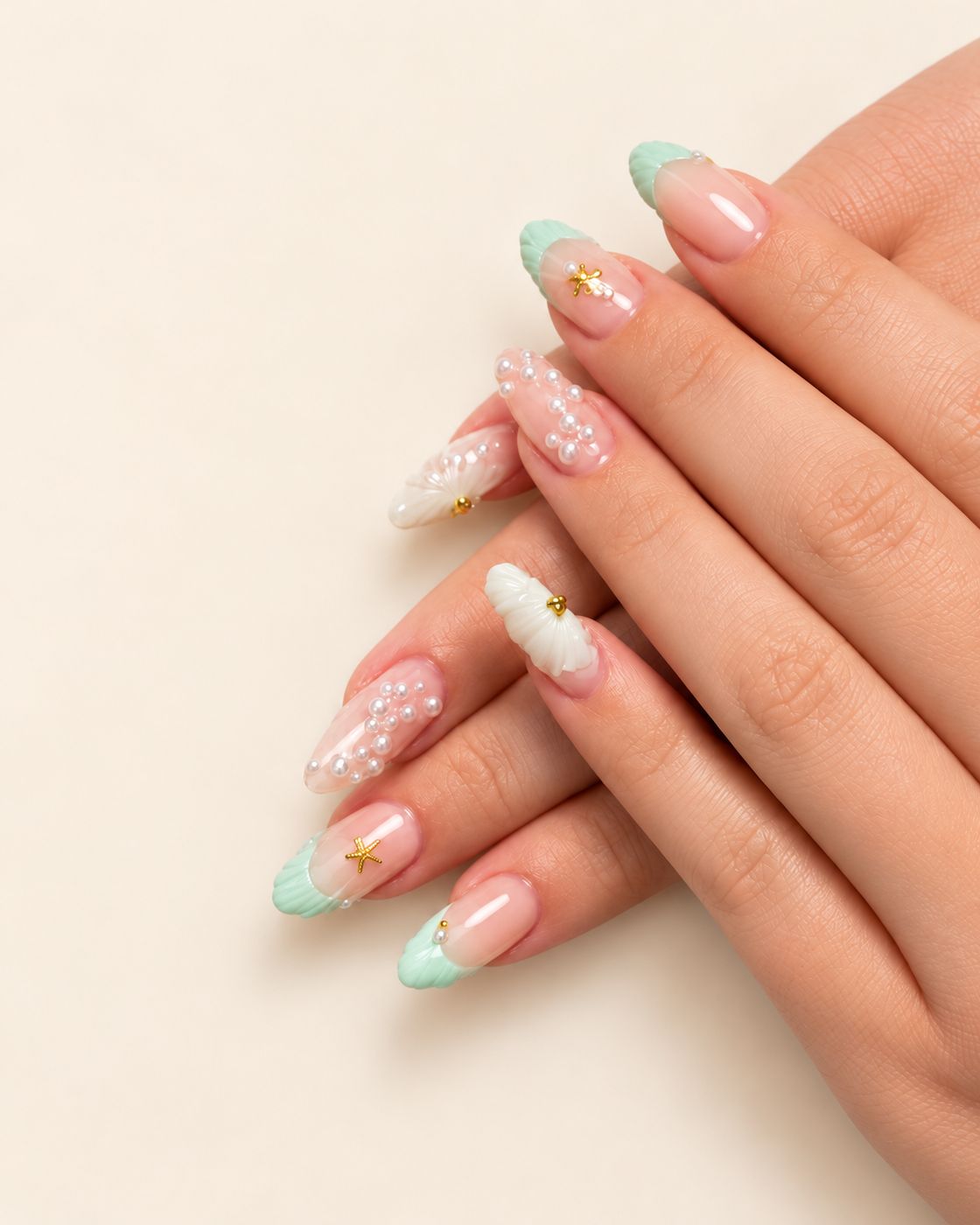 Almond nails with mint shell French tips, pearls and gold starfish charms