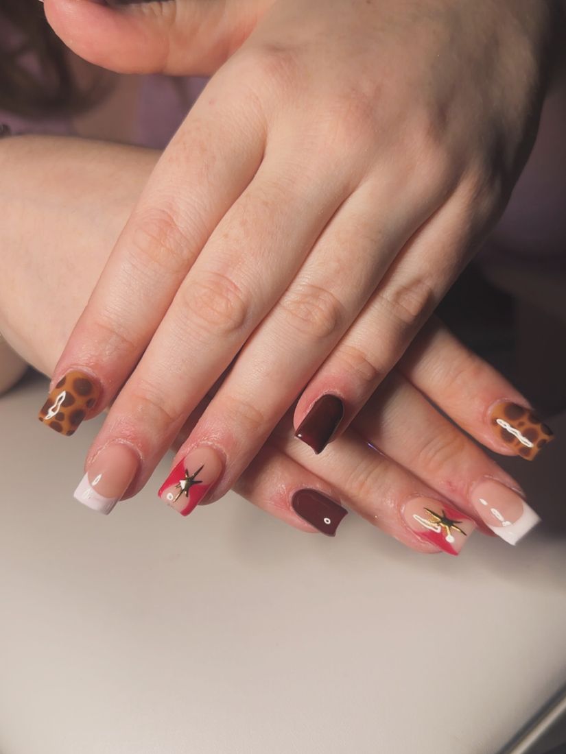 Nude nails with brown and red accents and white French tips
