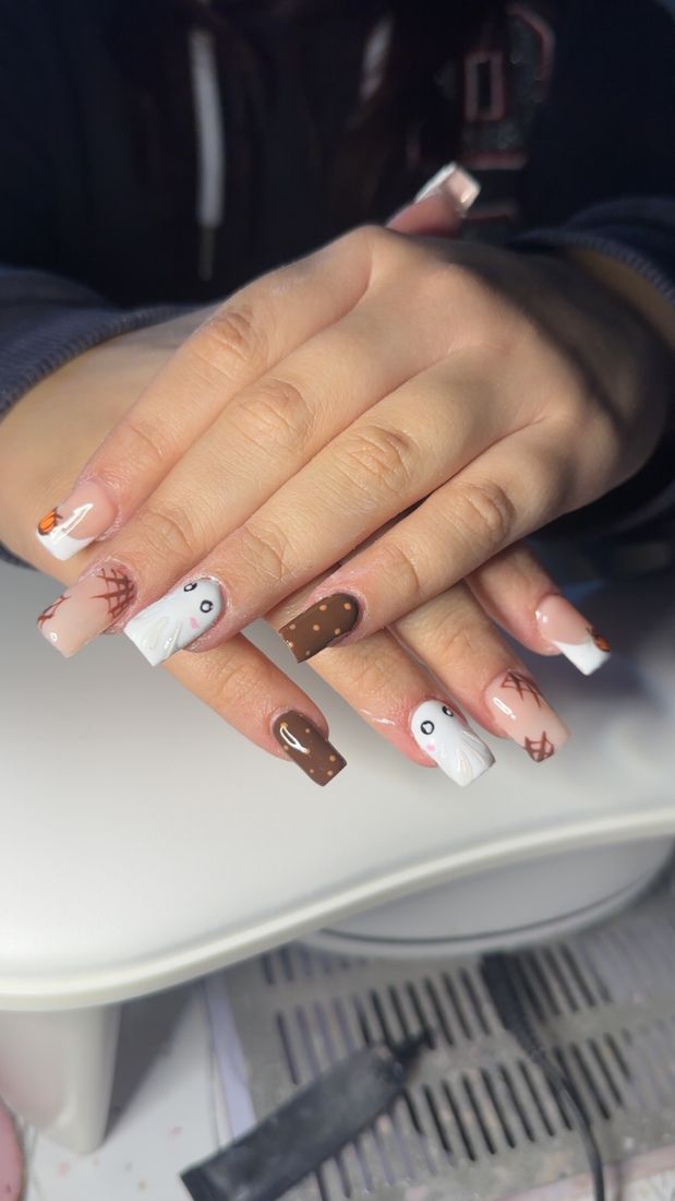 Square nails with brown, white and charm details
